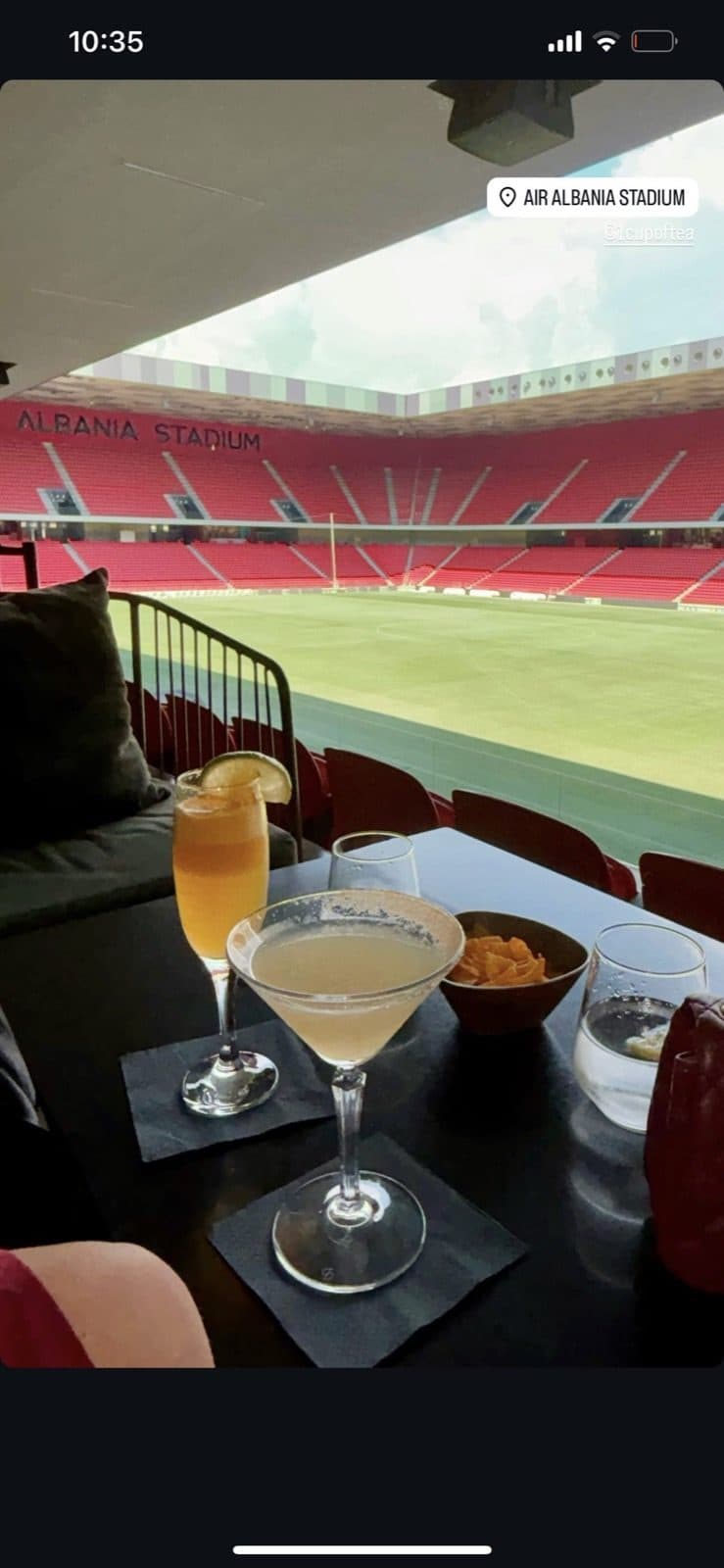 Guest photo of three cocktails on the table with the pitch behind