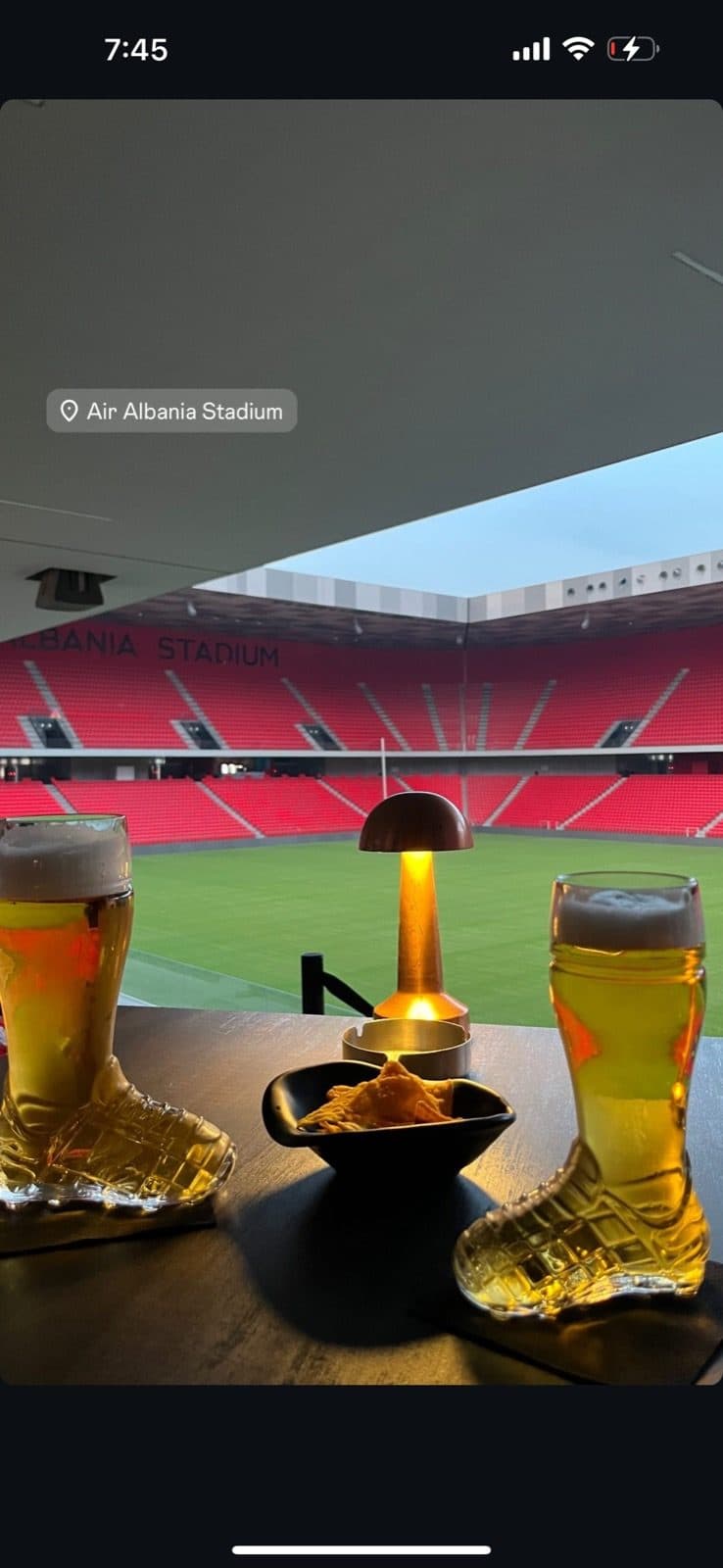 Guest photo of beer served in boot-shaped glasses with the pitch behind