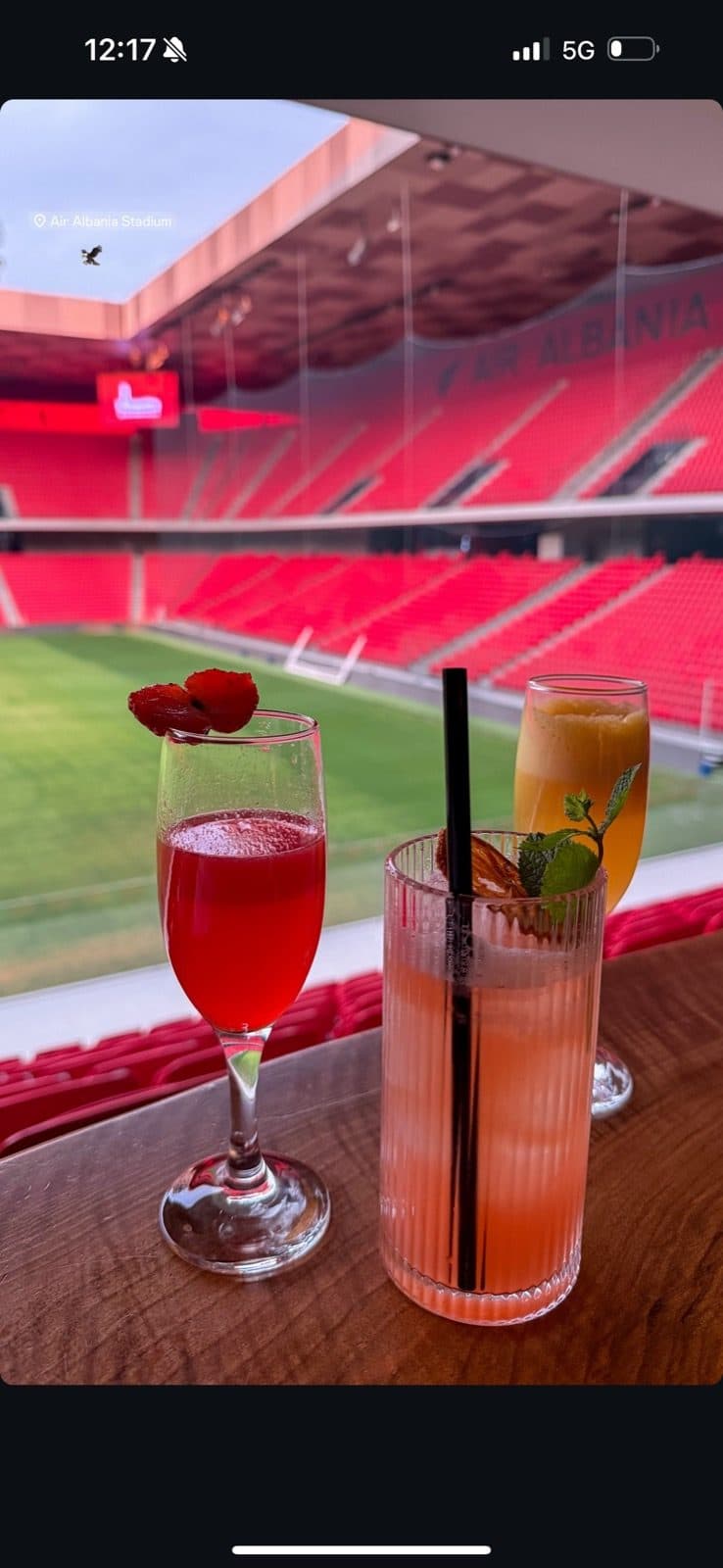 Guest photo of three drinks on the table with the pitch behind