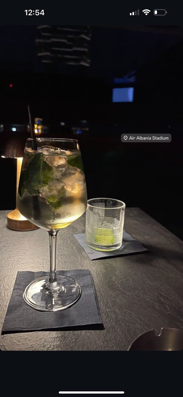 Guest photo of the lounge at night with the city view