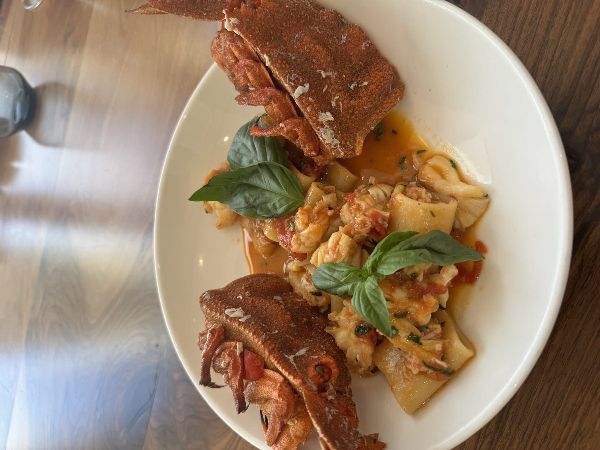 Spaghetti with langoustine, held up tableside