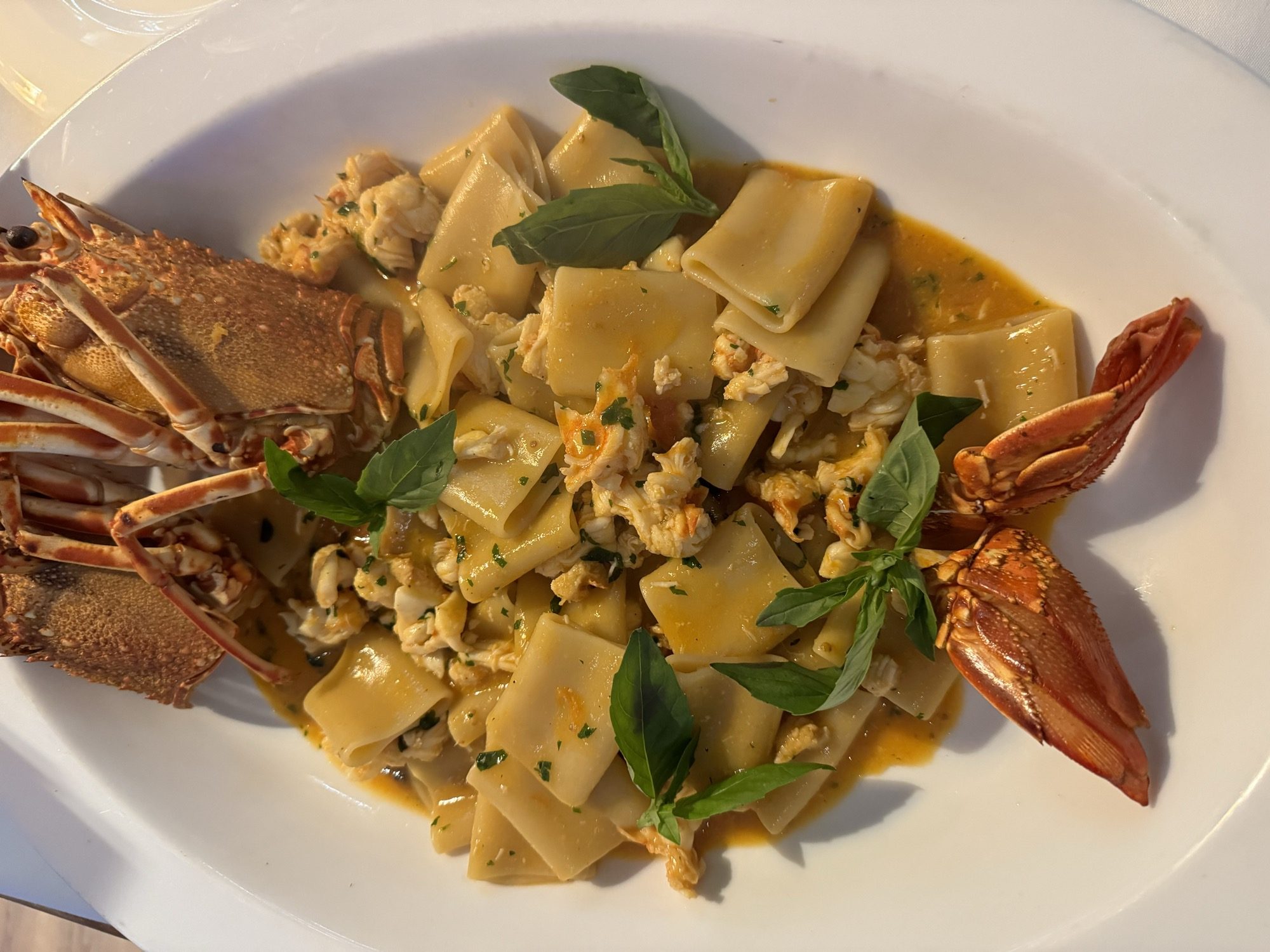 Pappardelle with crab and langoustine, finished with basil