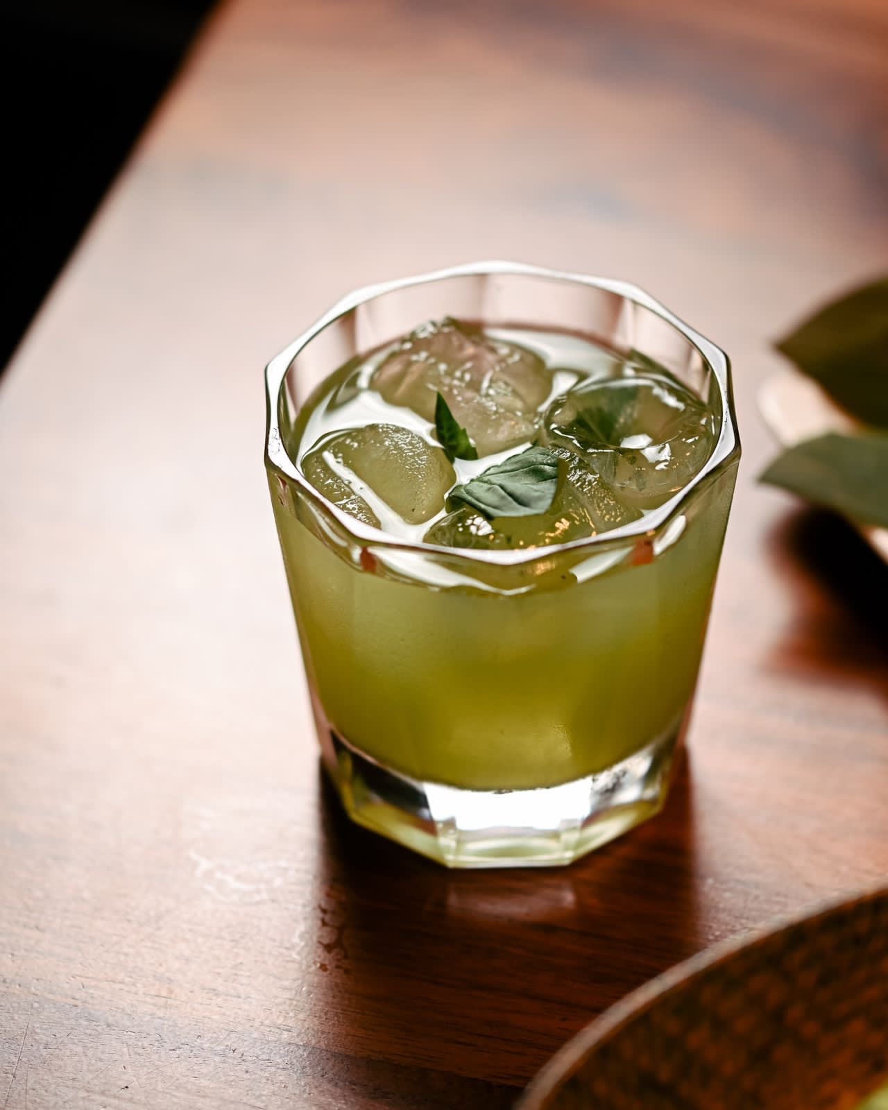 A cocktail with fresh mint and ice on the table