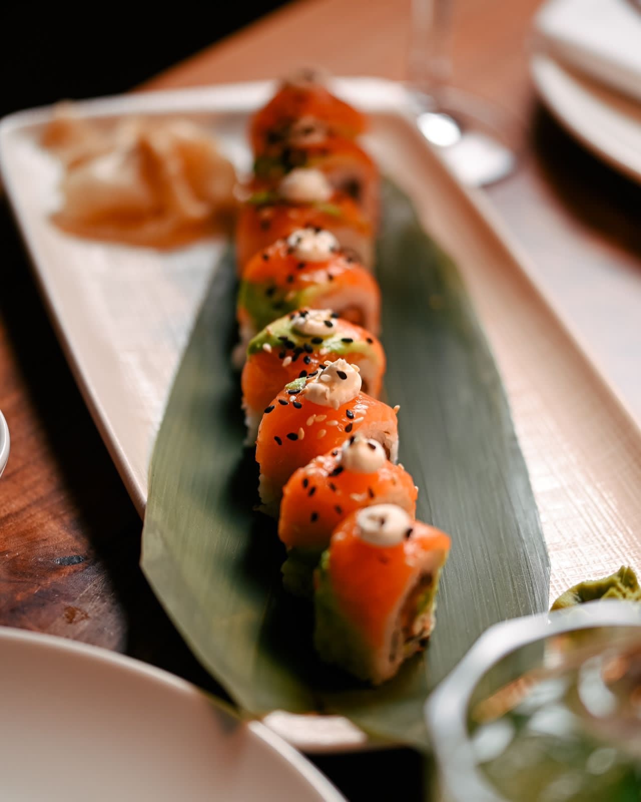 Salmon roll platter served on a banana leaf